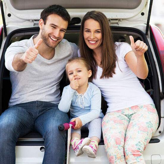 28346240 - family in car showing thumbs up